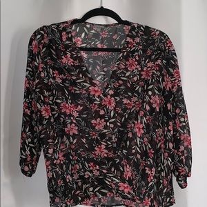 Black blouse with pink flower patterns.